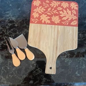 Used cheese board with utensils.  Beautiful